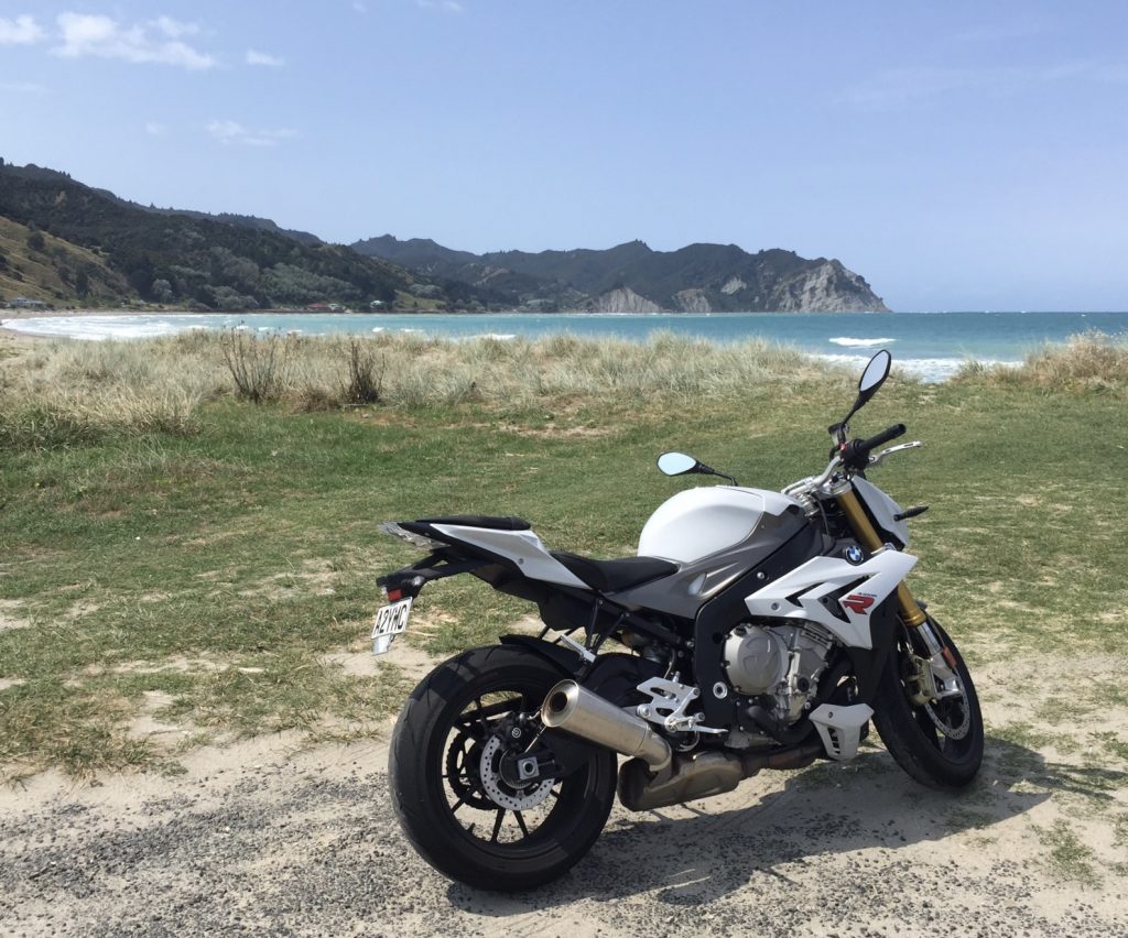 BMW S1000R motorcycle parked on a beach in Tairawhiti.