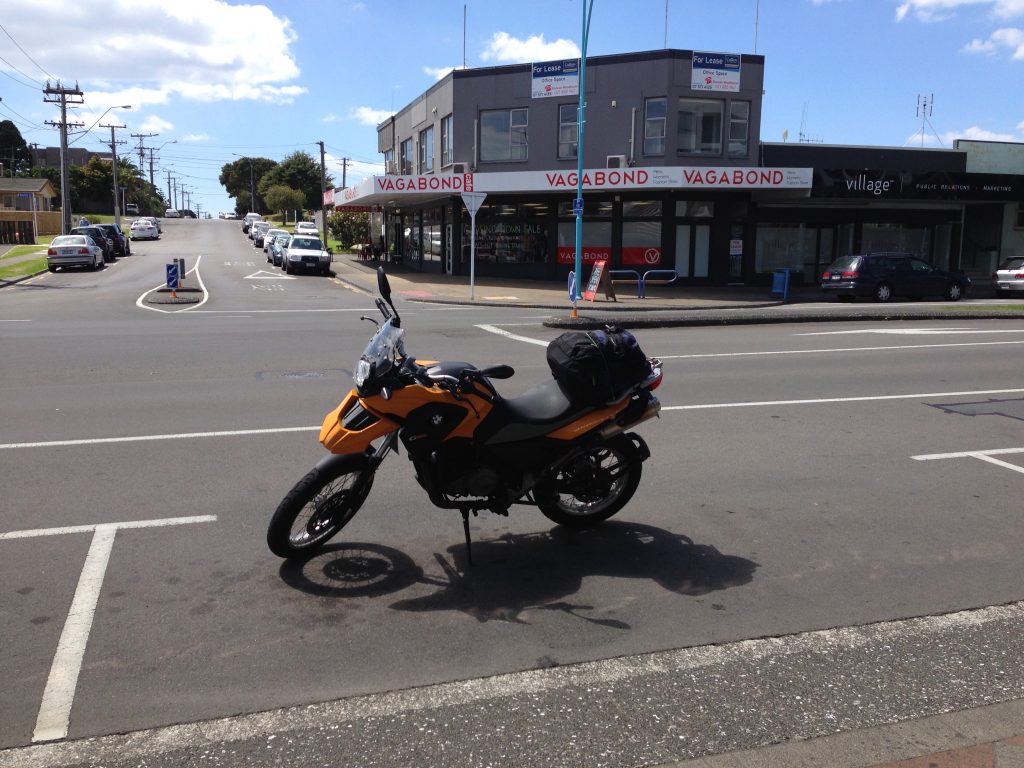 BMW G650GS motorcycle parked in front of Vagabond Cafe in Mount Maunganui.