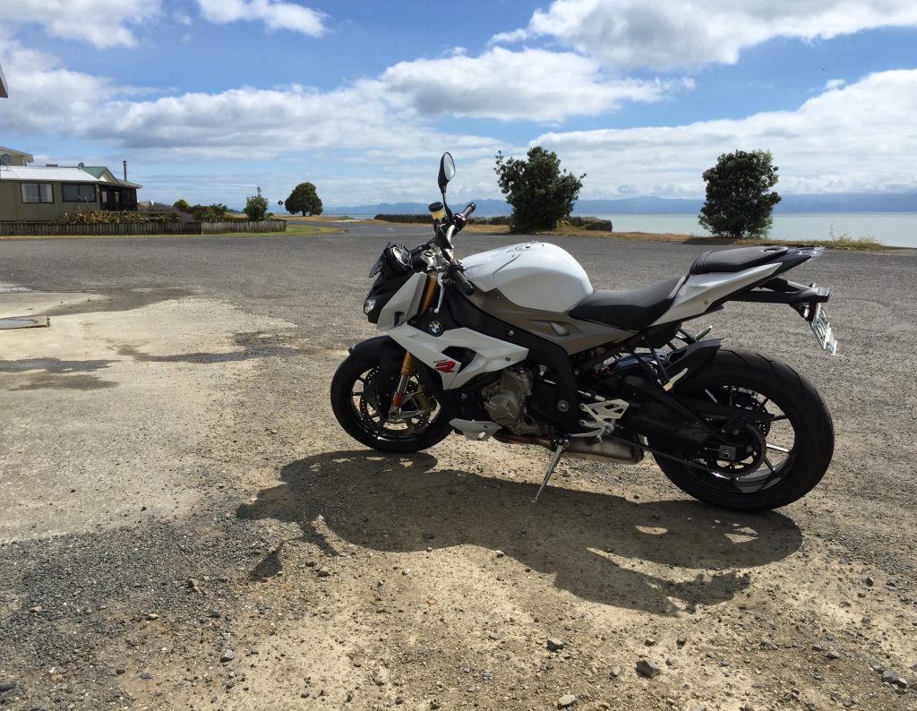 BMW S1000R motorcycle parked on gravel in the seaside town of Miranda.