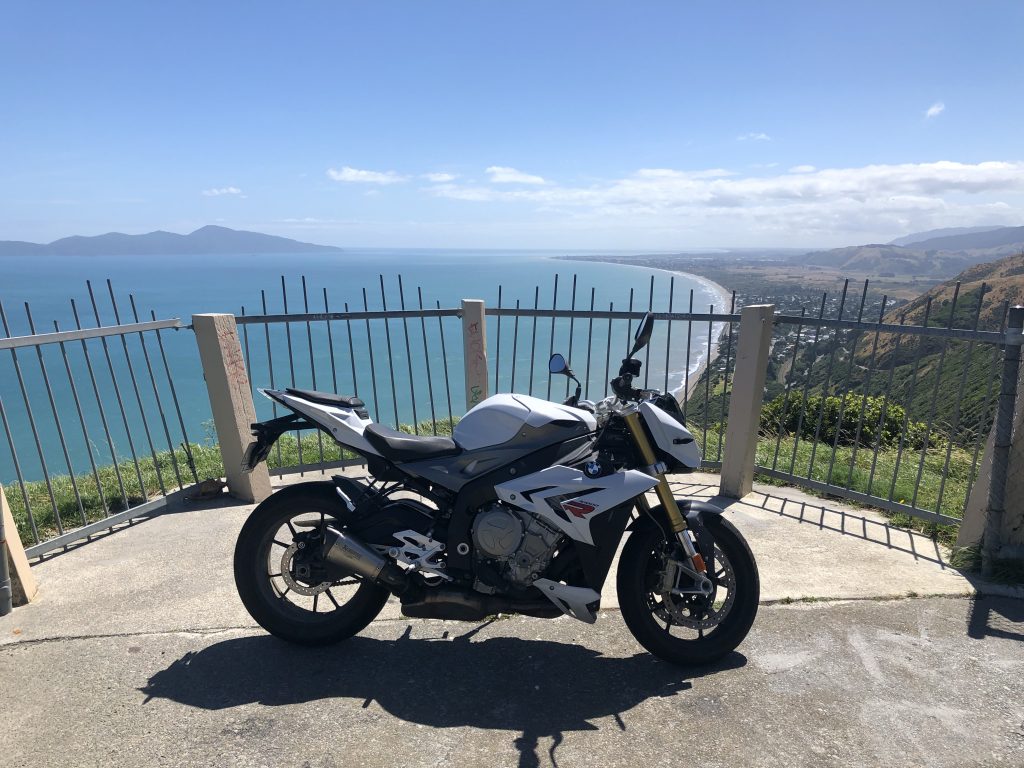 A BMW S1000R parked at an overlook on the Paekakariki road.