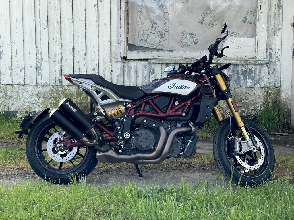 FTR 1200 motorcycle parked in front of a derelict house in the Wairarapa.