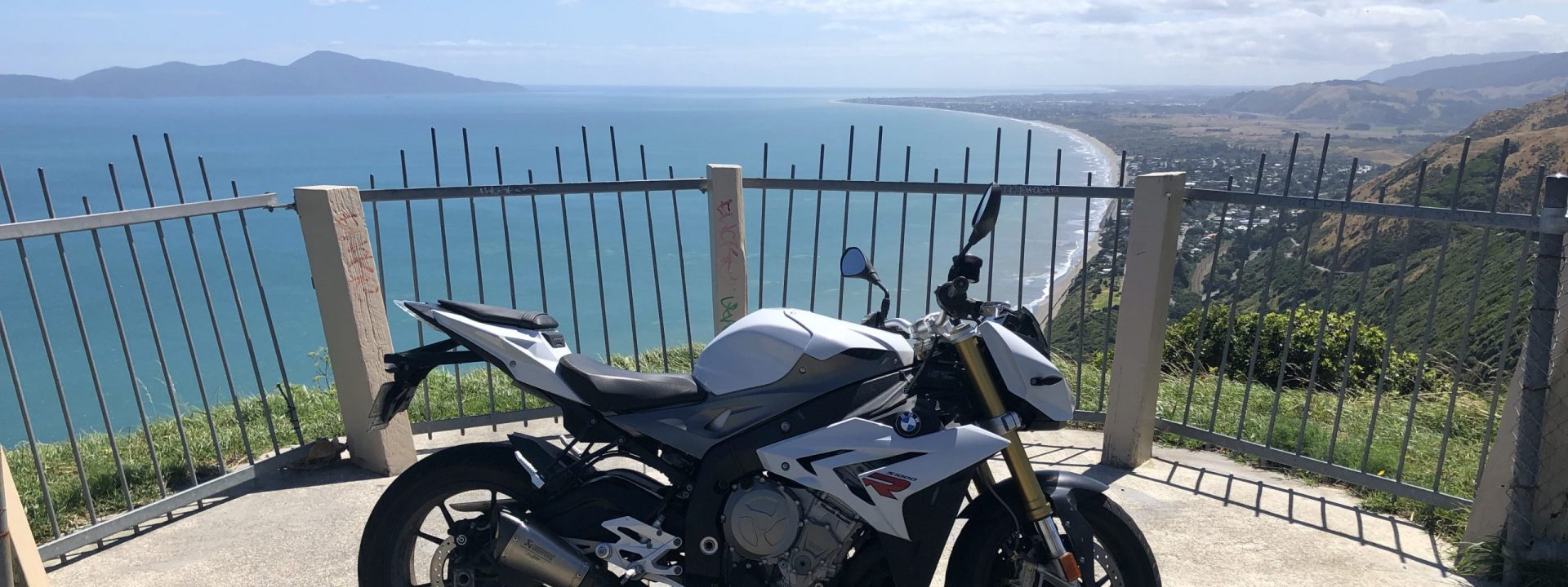 A BMW S1000R parked at an overlook on the Paekakariki road.