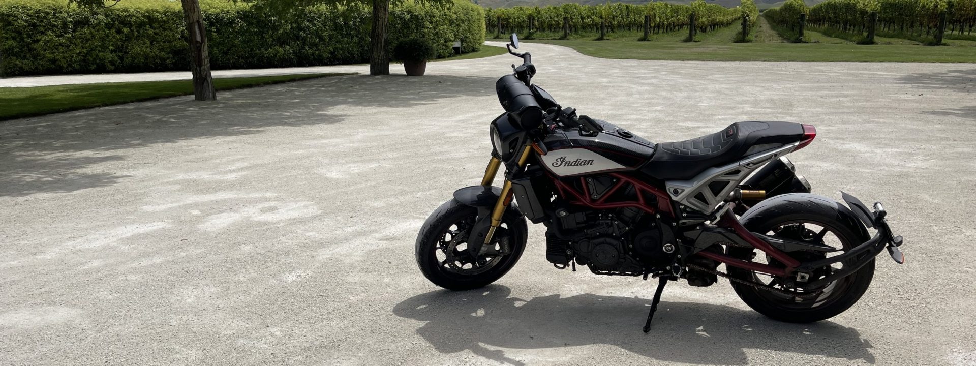 An Indian FTR 1200 motorcycle in the carpark at Alpha Domus vineyard.